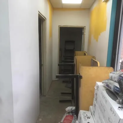 Hallway before painting, patched bare walls
