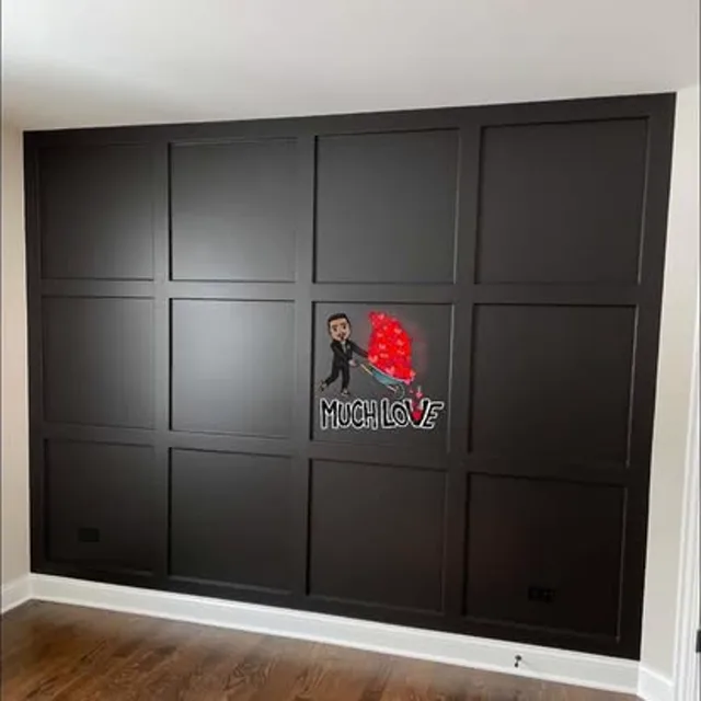 Dark board-and-batten accent wall with white base trim