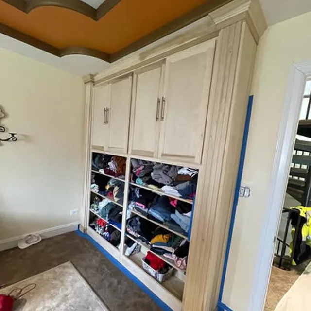 Cream built-in cabinetry with brass hardware