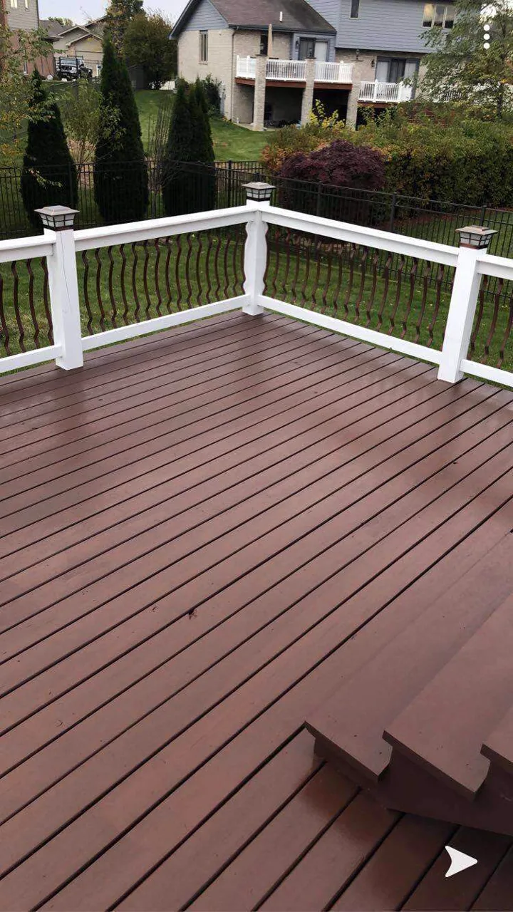 Raised wood deck and stairs refinished with warm stain