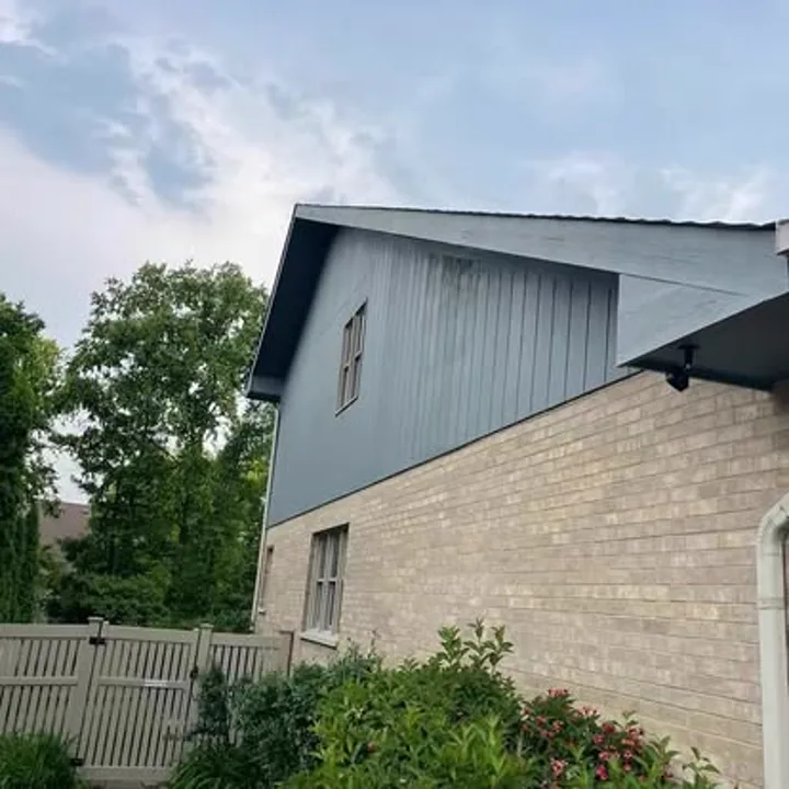 Rear home addition with freshly painted slate siding